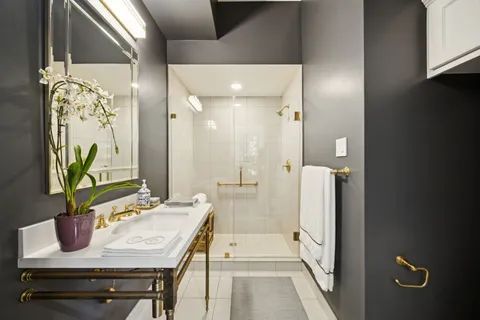 a bathroom with a sink a mirror and a shower