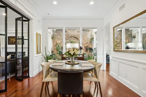 a view of a dining room with furniture window and wooden floor