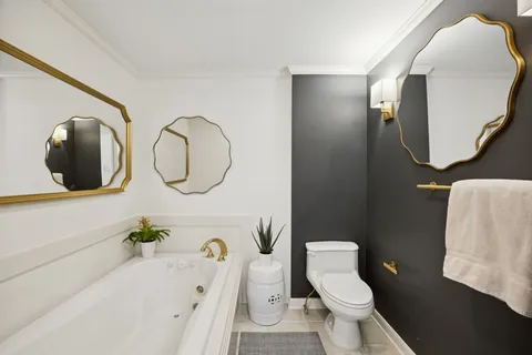 a bathroom with a toilet a sink and mirror