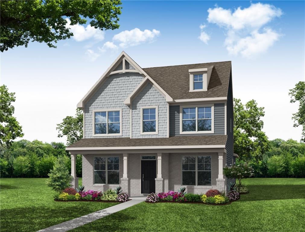 a front view of a house with garden and garage