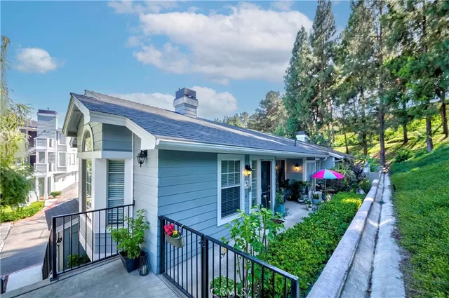 a front view of a house with plants