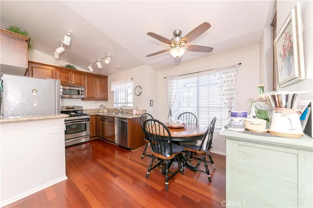 a kitchen with granite countertop a stove sink and refrigerator