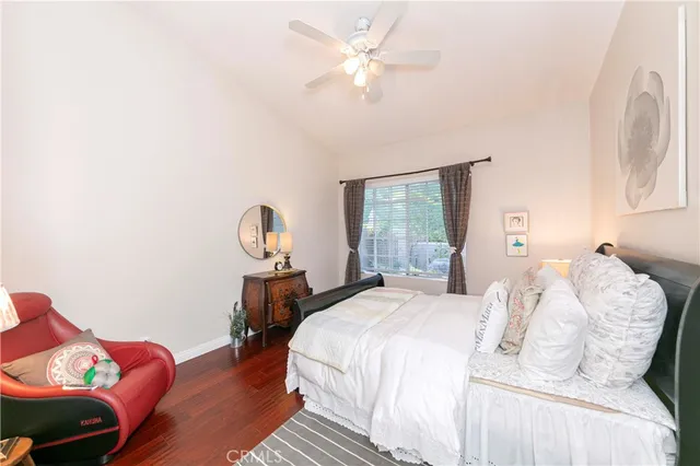 a bedroom with a bed a mirror and a large window