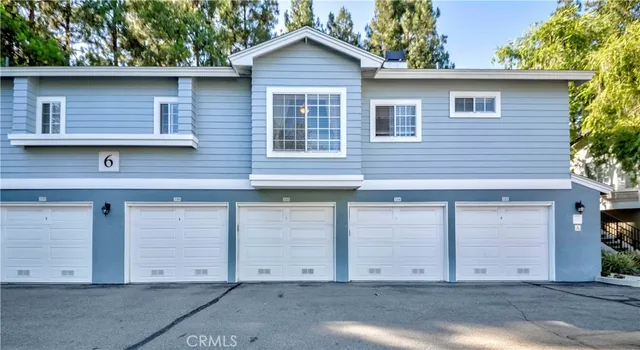 a front view of a house with parking space