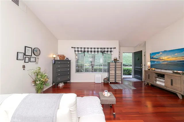 a living room with furniture large window and a flat screen tv