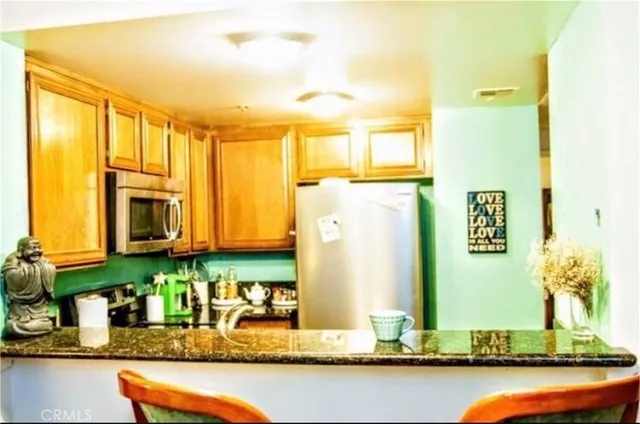 a bathroom with sinks granite tub and a mirror