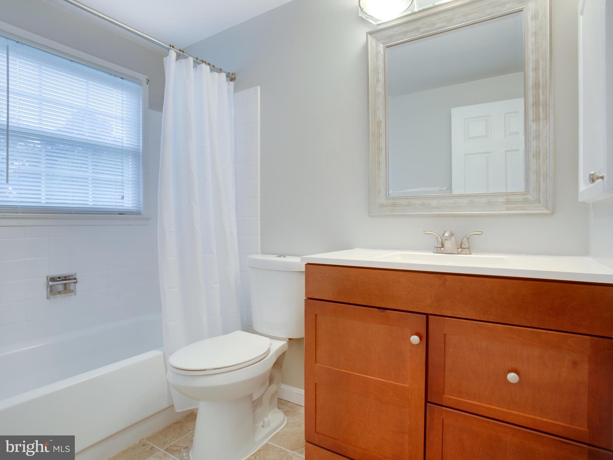 13132 Moss Ranch Lane Fairfax, VA 22033 - Photo 20 of 30 a bathroom with a sink a toilet and shower