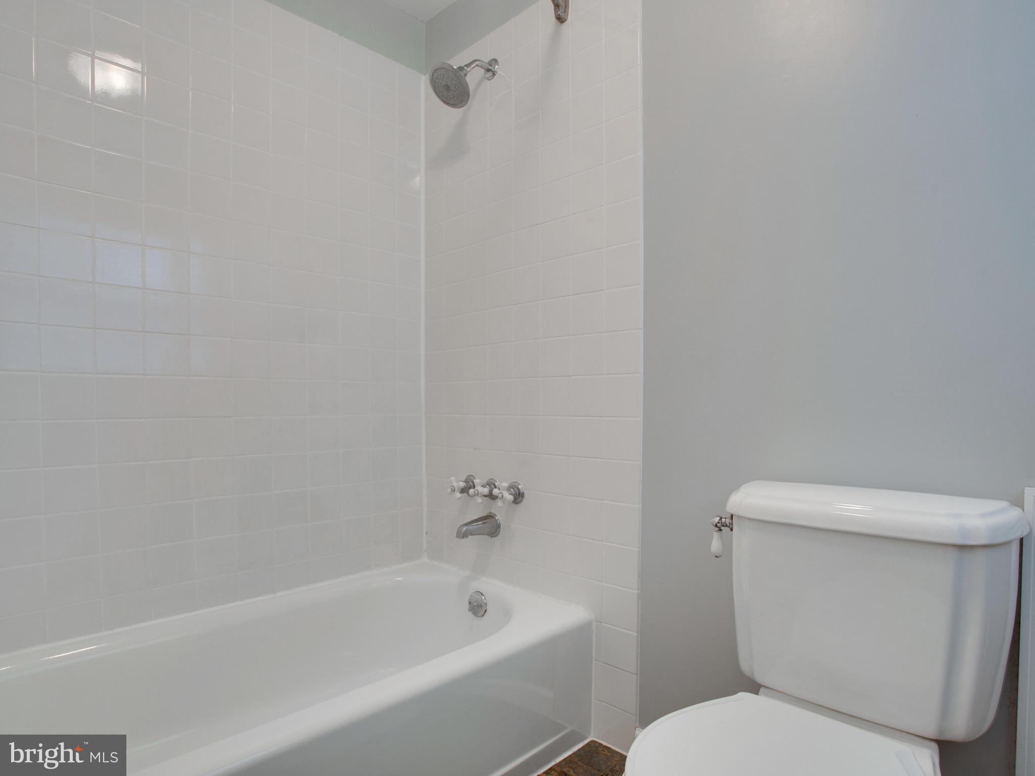 13132 Moss Ranch Lane Fairfax, VA 22033 - Photo 28 of 30 a white toilet sitting next to a bath tub