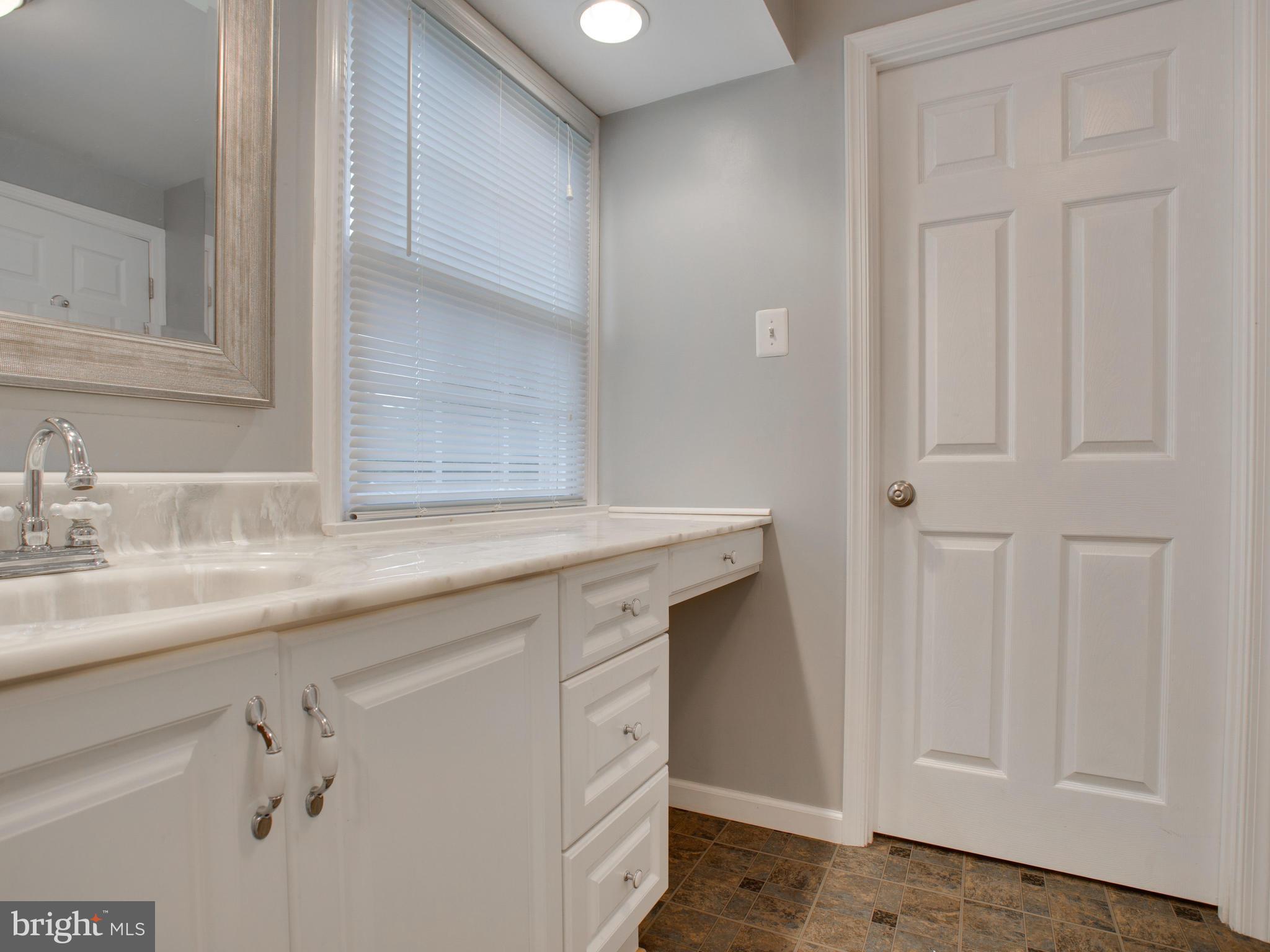 13132 Moss Ranch Lane Fairfax, VA 22033 - Photo 29 of 30 a bathroom with a sink and a mirror