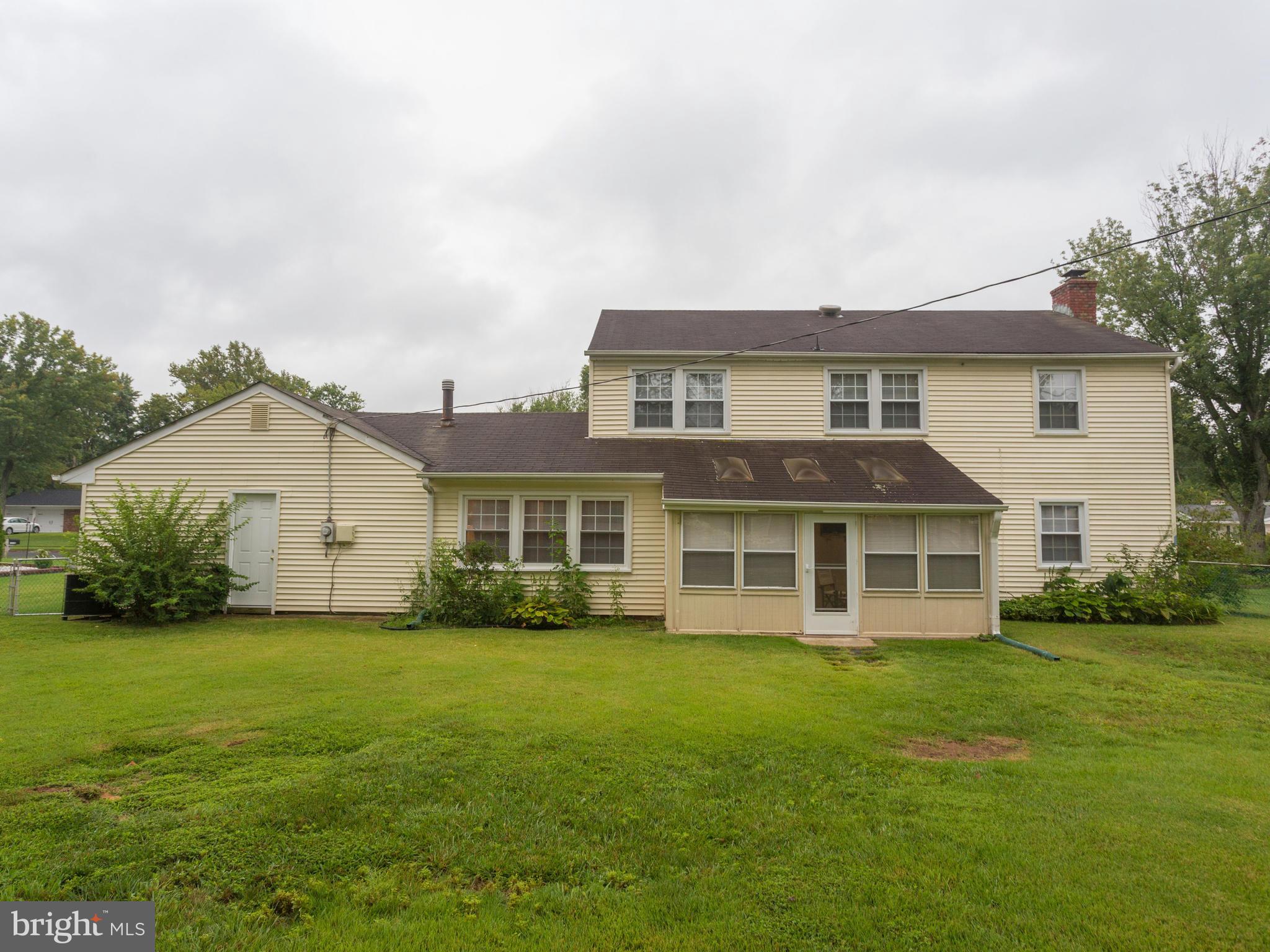 13132 Moss Ranch Lane Fairfax, VA 22033 - Photo 4 of 30 a house that is sitting in the grass with large trees and plants