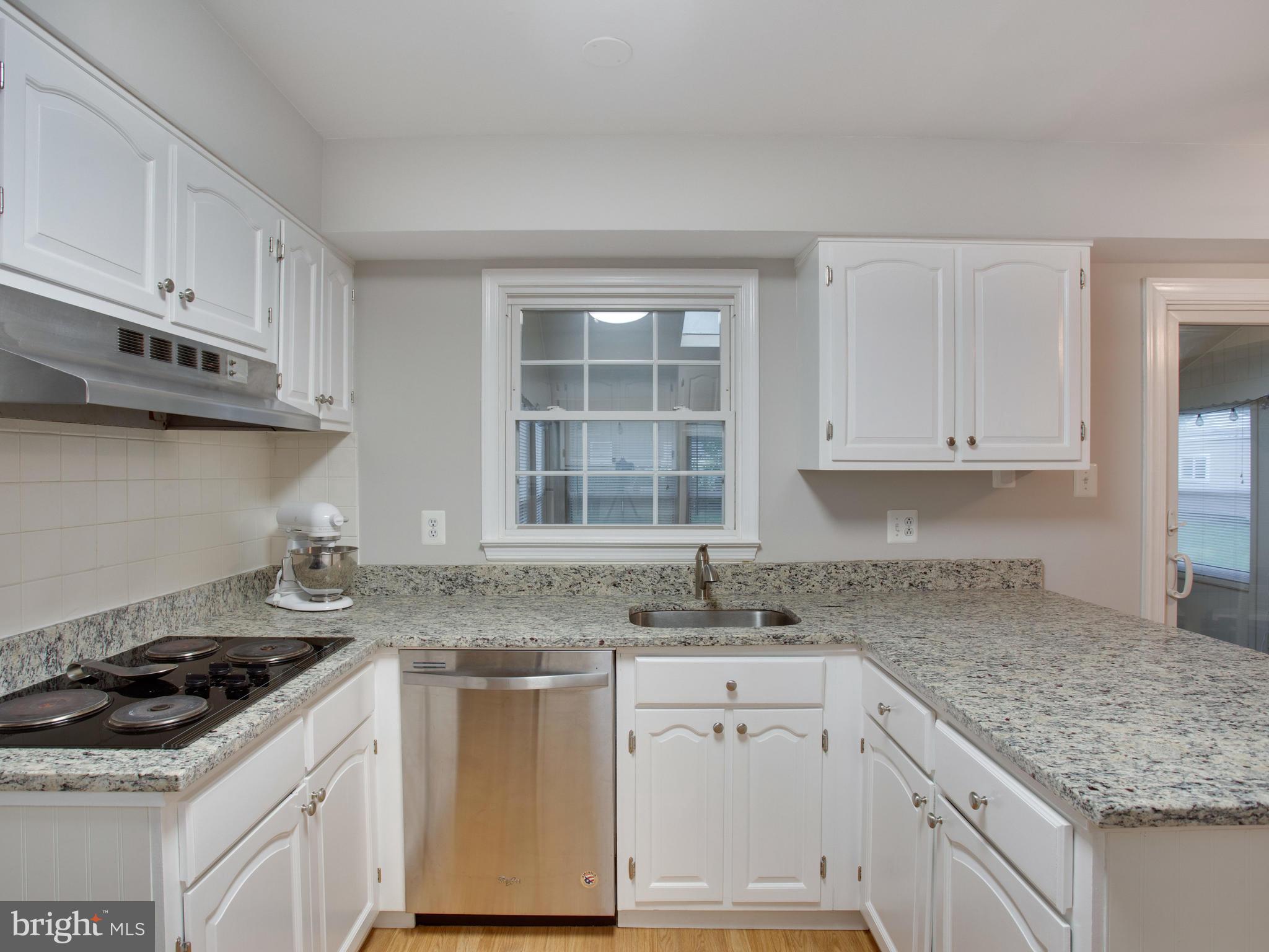 13132 Moss Ranch Lane Fairfax, VA 22033 - Photo 8 of 30 a kitchen with granite countertop a sink stove and cabinets
