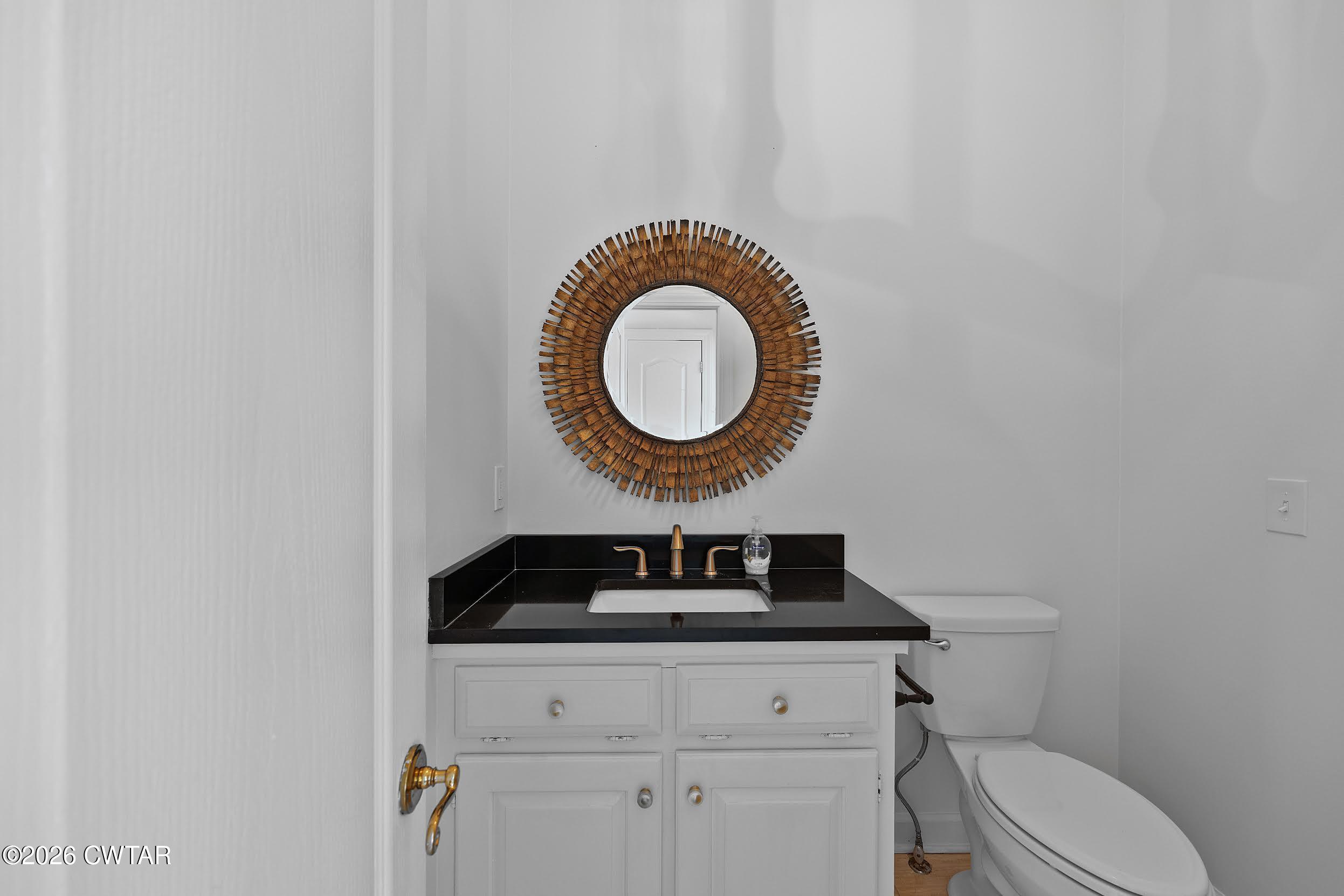 58 Huntington Place Jackson, TN 38305 - Photo 17 of 38 a bathroom with a granite countertop toilet and sink