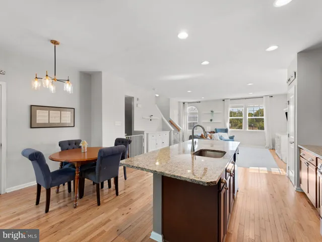 a dining room with furniture and wooden floor
