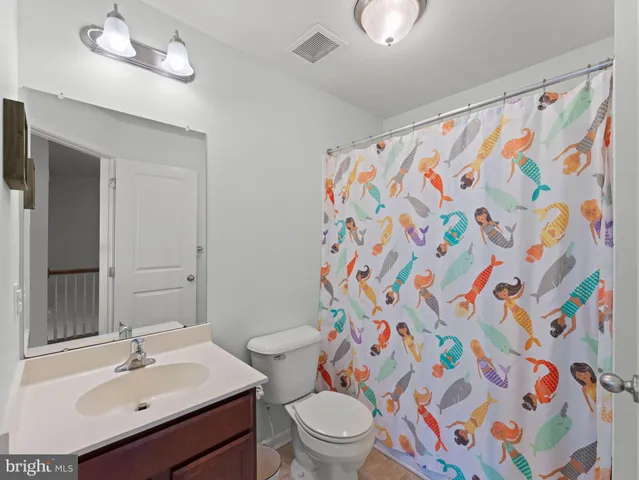 a bathroom with a sink toilet and a mirror