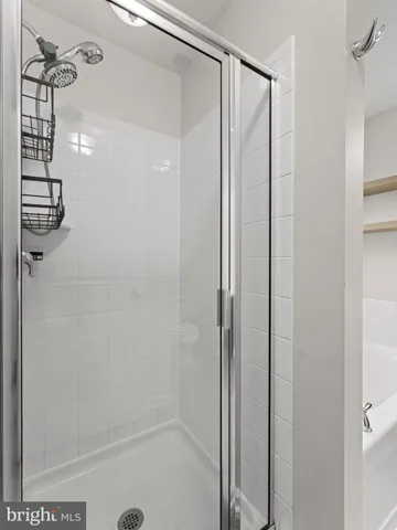 a spacious bedroom with a bed and a flat screen tv