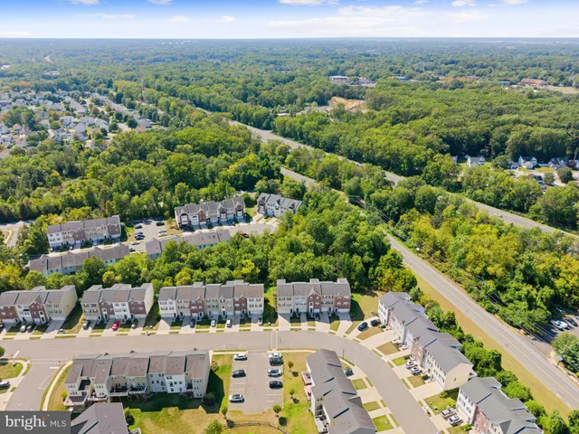 an aerial view of multiple houses with yard