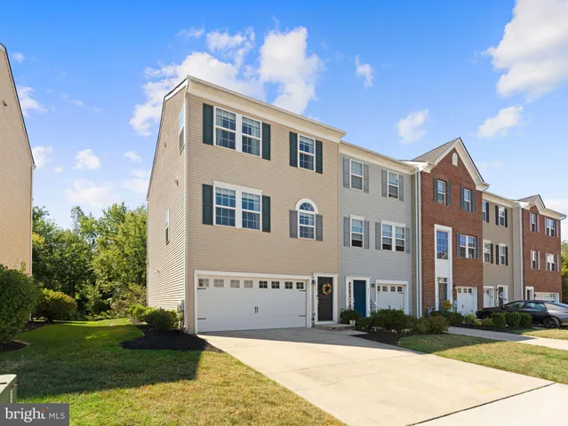a view of a white building among the street with palm trees