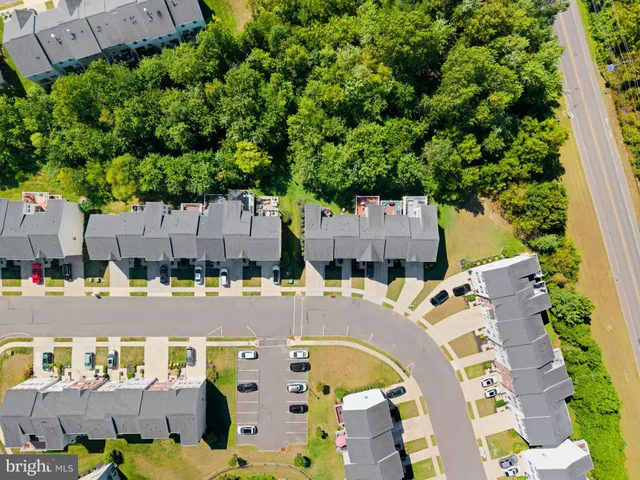 an aerial view of residential houses with outdoor space and street view