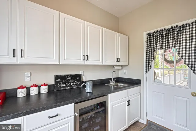 a view of living room filled with furniture and a chandelier