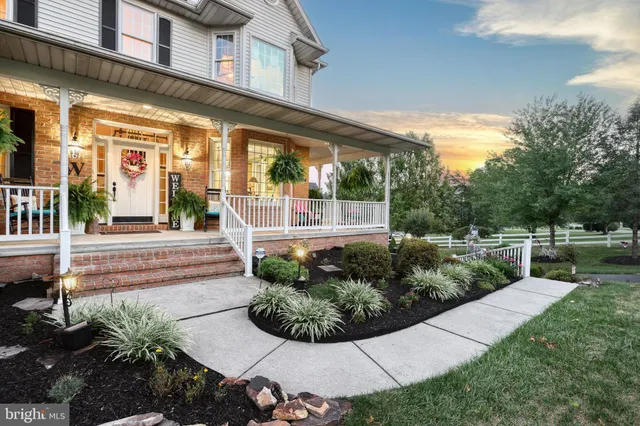 a view of a house with sitting area and garden