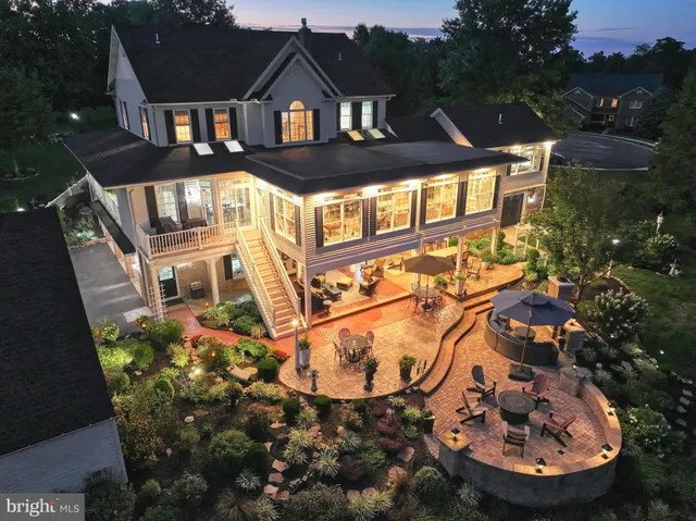 a view of a patio with a dining table and chairs with a fire pit