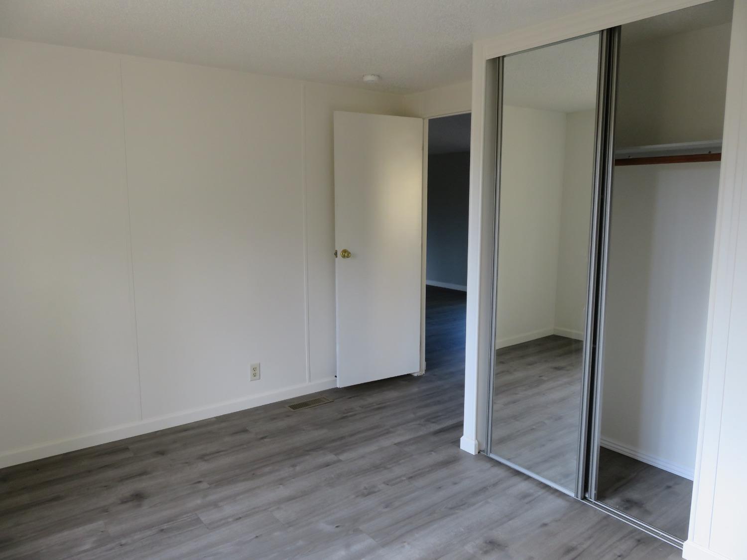 4426 Bald Mountain Road West Point, CA 95255 - Photo 23 of 45 an empty room with wooden floor closet and windows