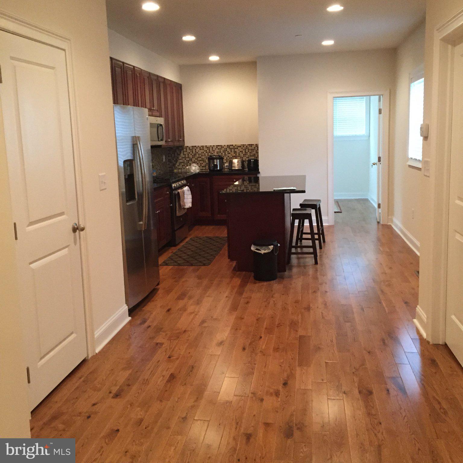 4080 Spring Garden Street Philadelphia, PA 19104 - Photo 3 of 28 Modern kitchen with warm wood floors.