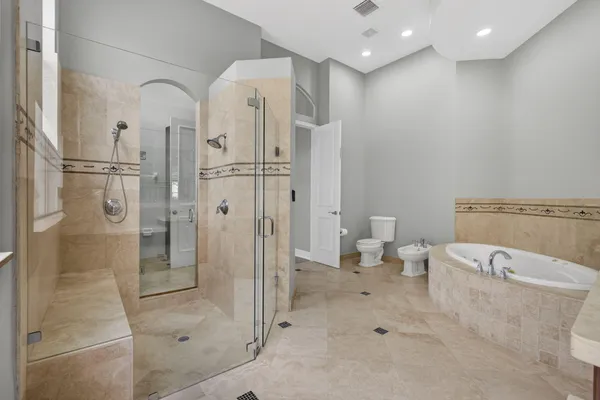 a large bathroom with a glass shower door