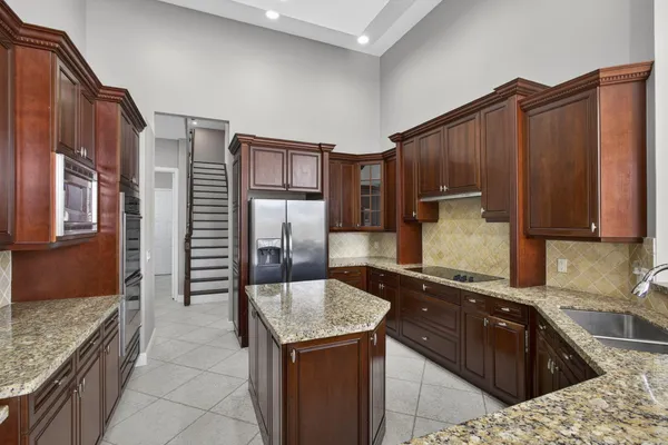 a kitchen with a sink refrigerator and microwave