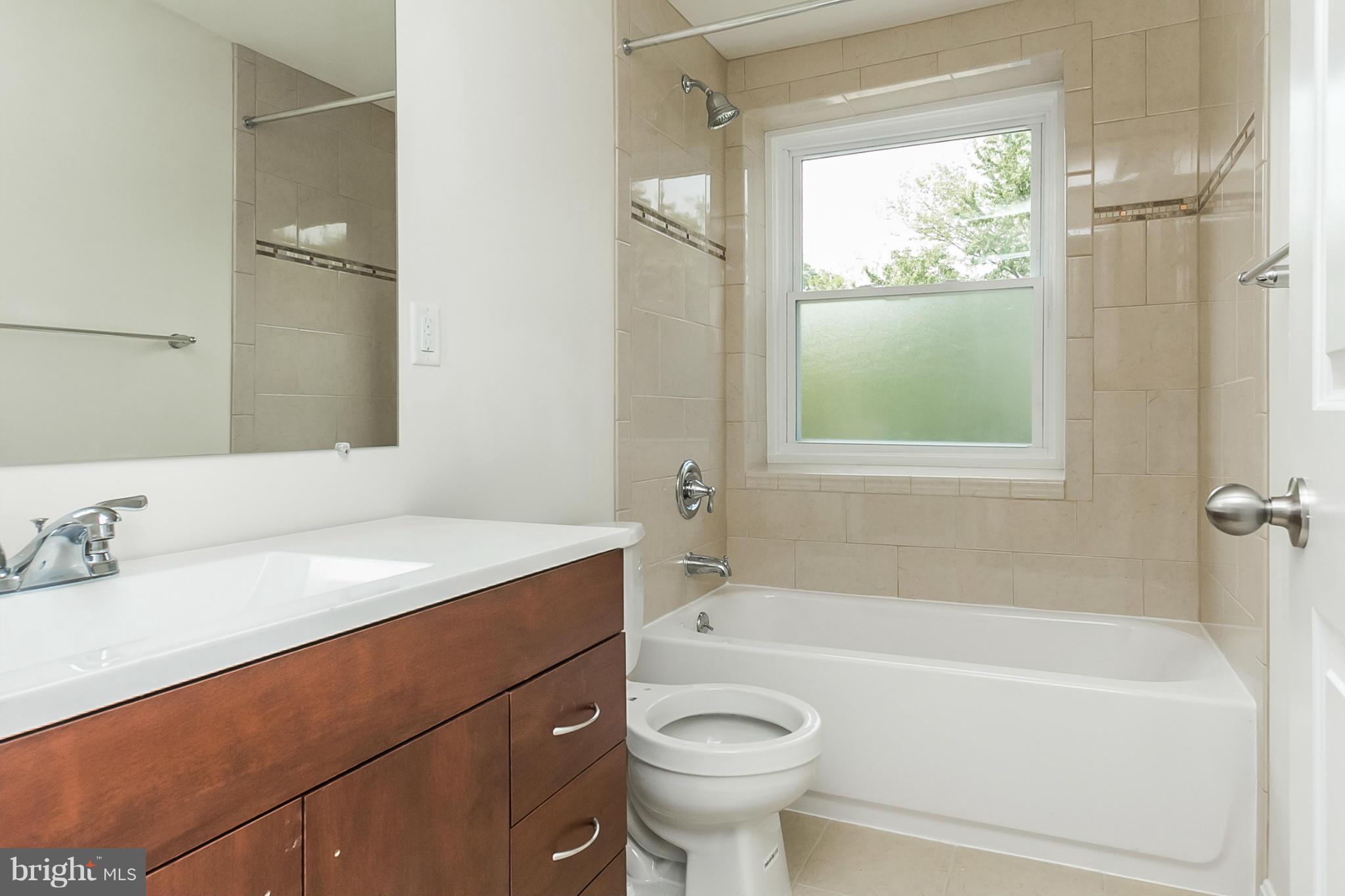16 Bladen Road Baltimore, MD 21221 - Photo 17 of 29 a bathroom with a sink toilet vanity and bathtub