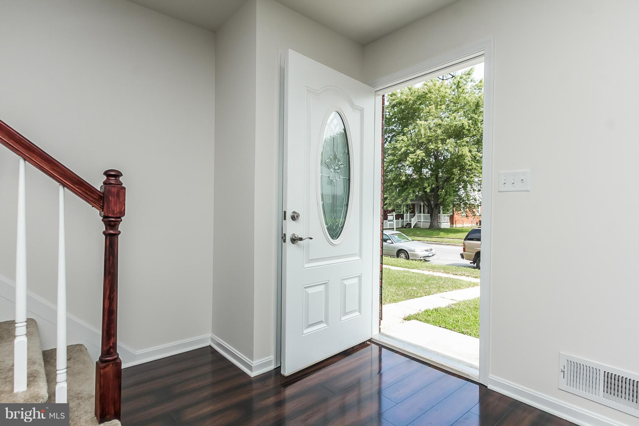 16 Bladen Road Baltimore, MD 21221 - Photo 3 of 29 a view of a hallway with wooden floor and windows