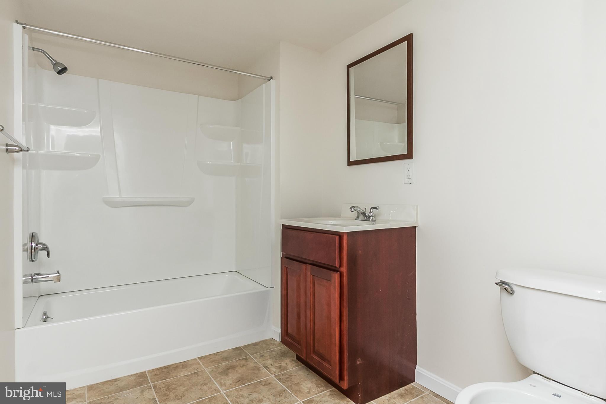 16 Bladen Road Baltimore, MD 21221 - Photo 26 of 29 a bathroom with a toilet a sink and bathtub