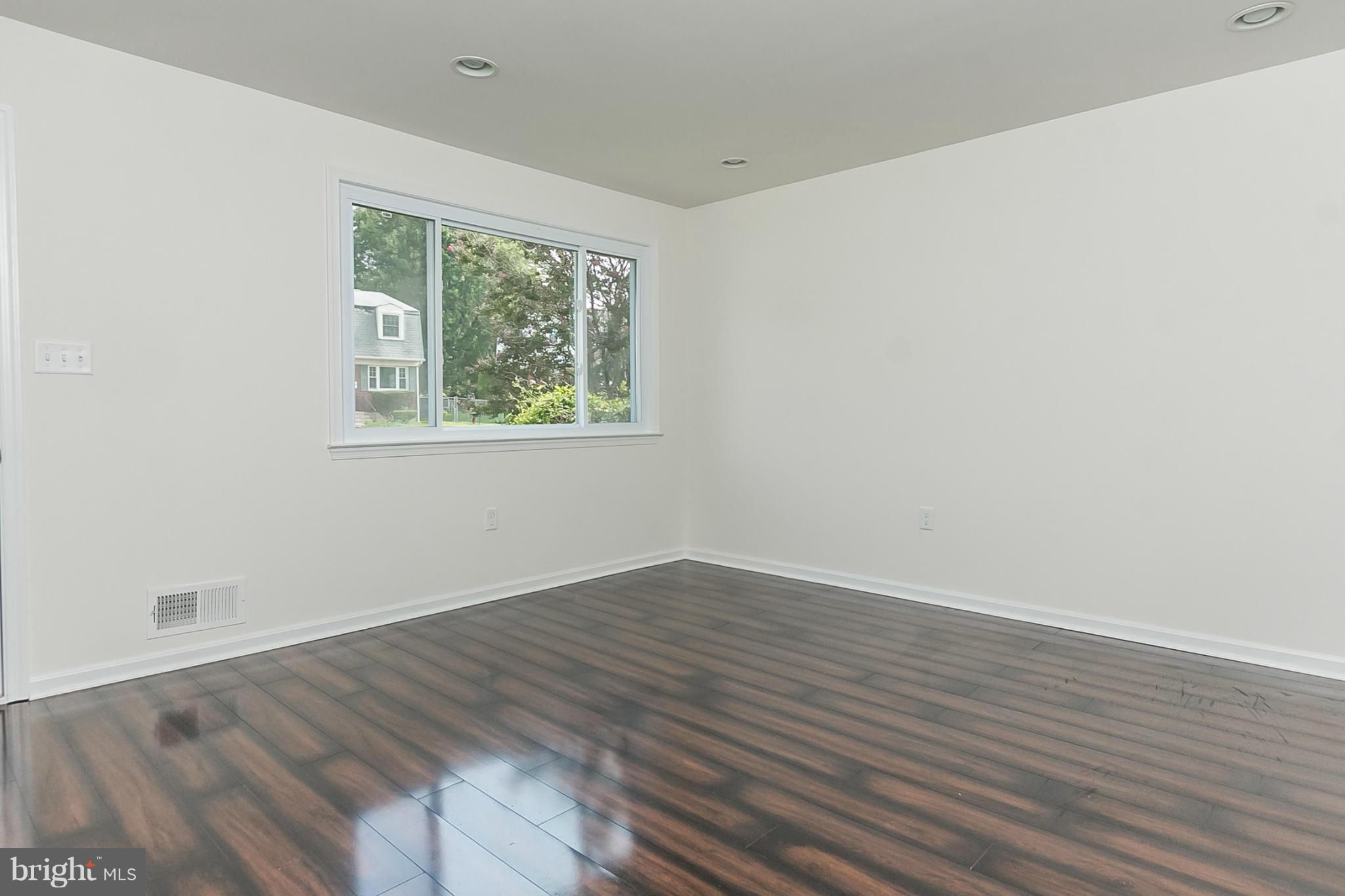 16 Bladen Road Baltimore, MD 21221 - Photo 4 of 29 wooden floor in an empty room with a window
