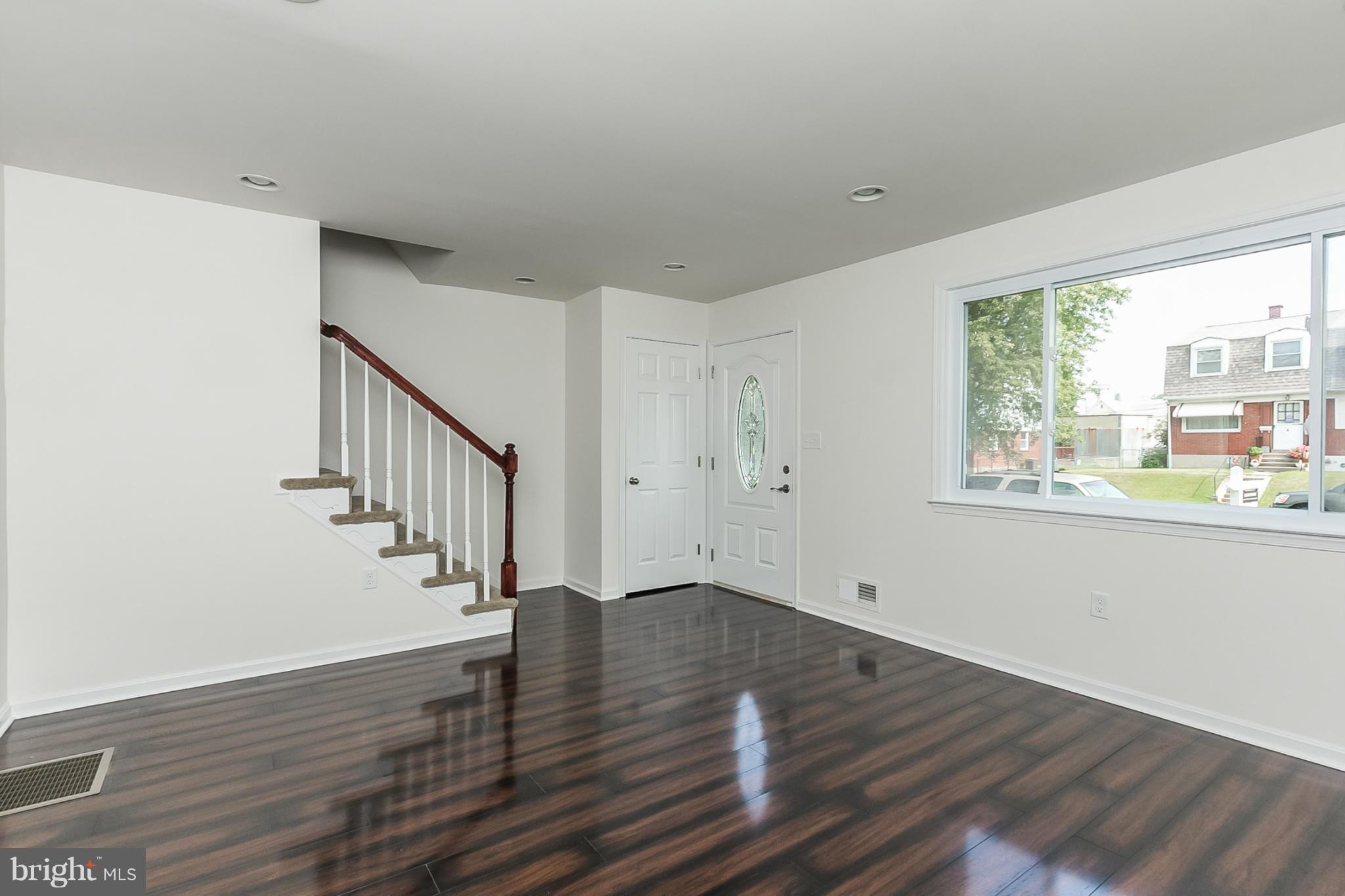 16 Bladen Road Baltimore, MD 21221 - Photo 5 of 29 a view of empty room with wooden floor and fan