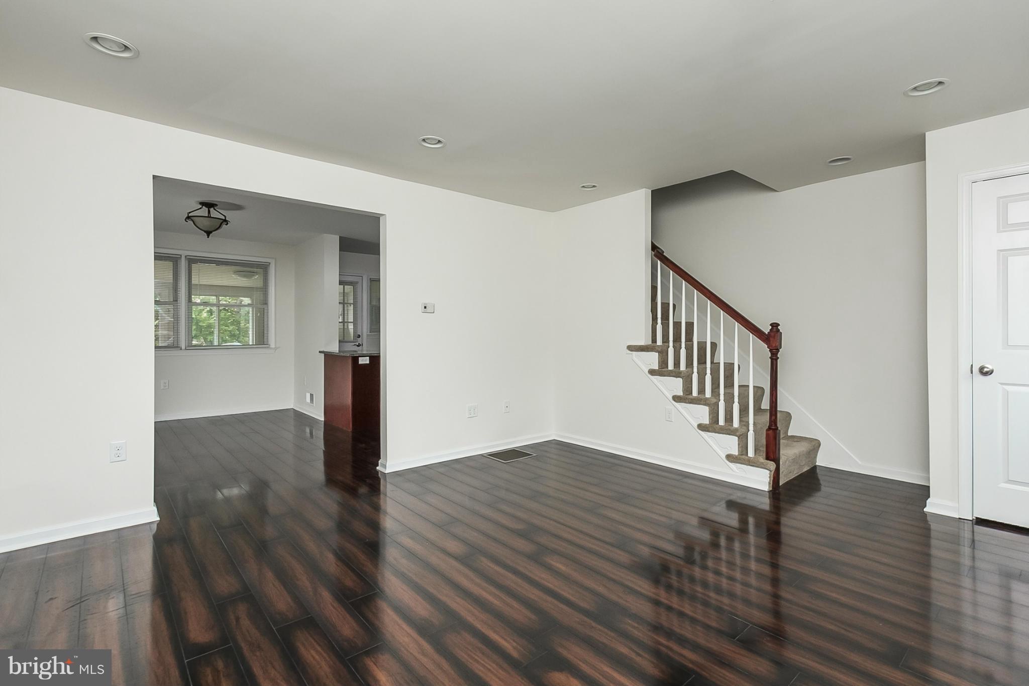 16 Bladen Road Baltimore, MD 21221 - Photo 6 of 29 a view of an empty room with wooden floor and a window