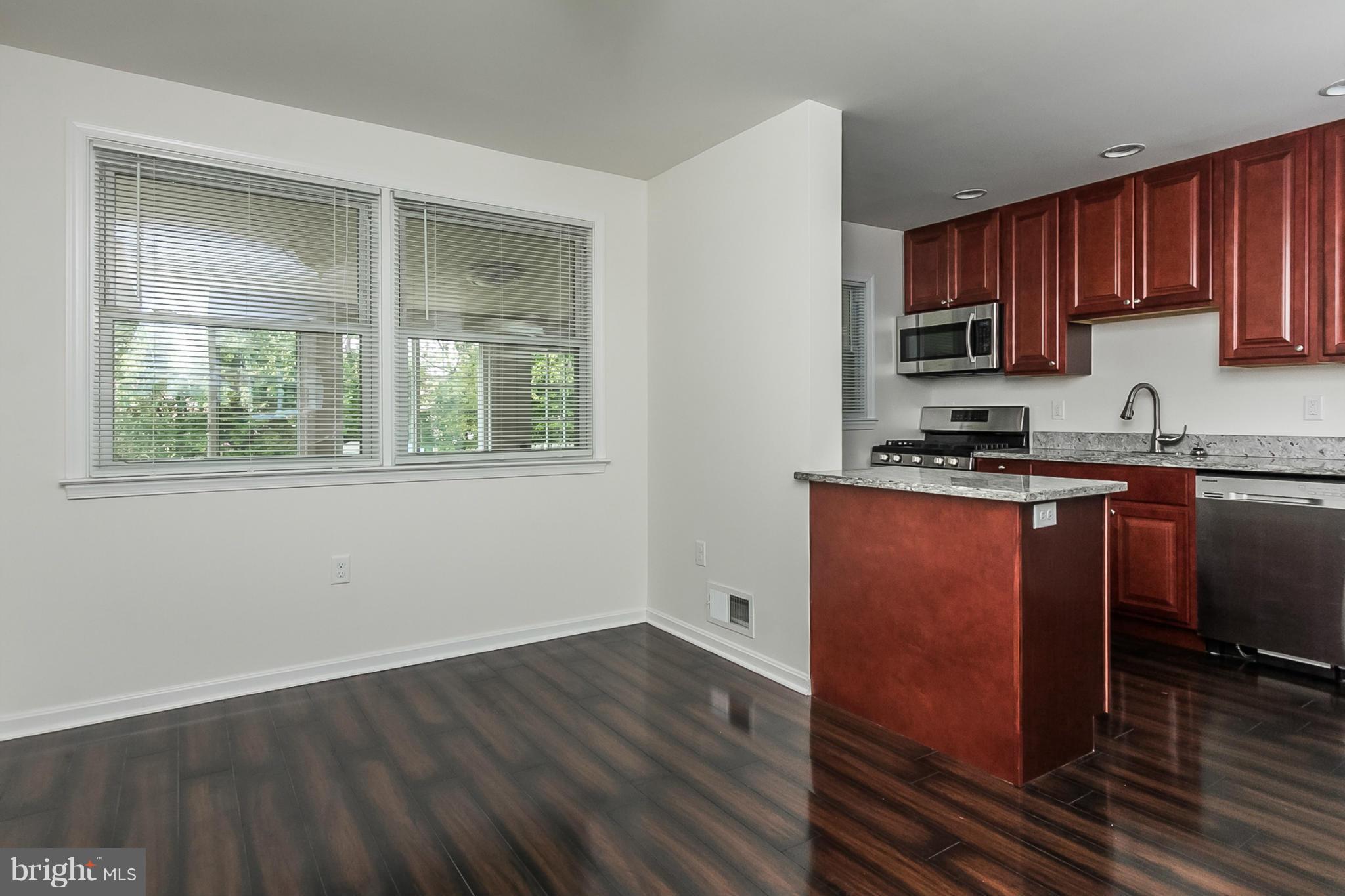16 Bladen Road Baltimore, MD 21221 - Photo 8 of 29 a kitchen with stainless steel appliances granite countertop a stove a sink and a microwave