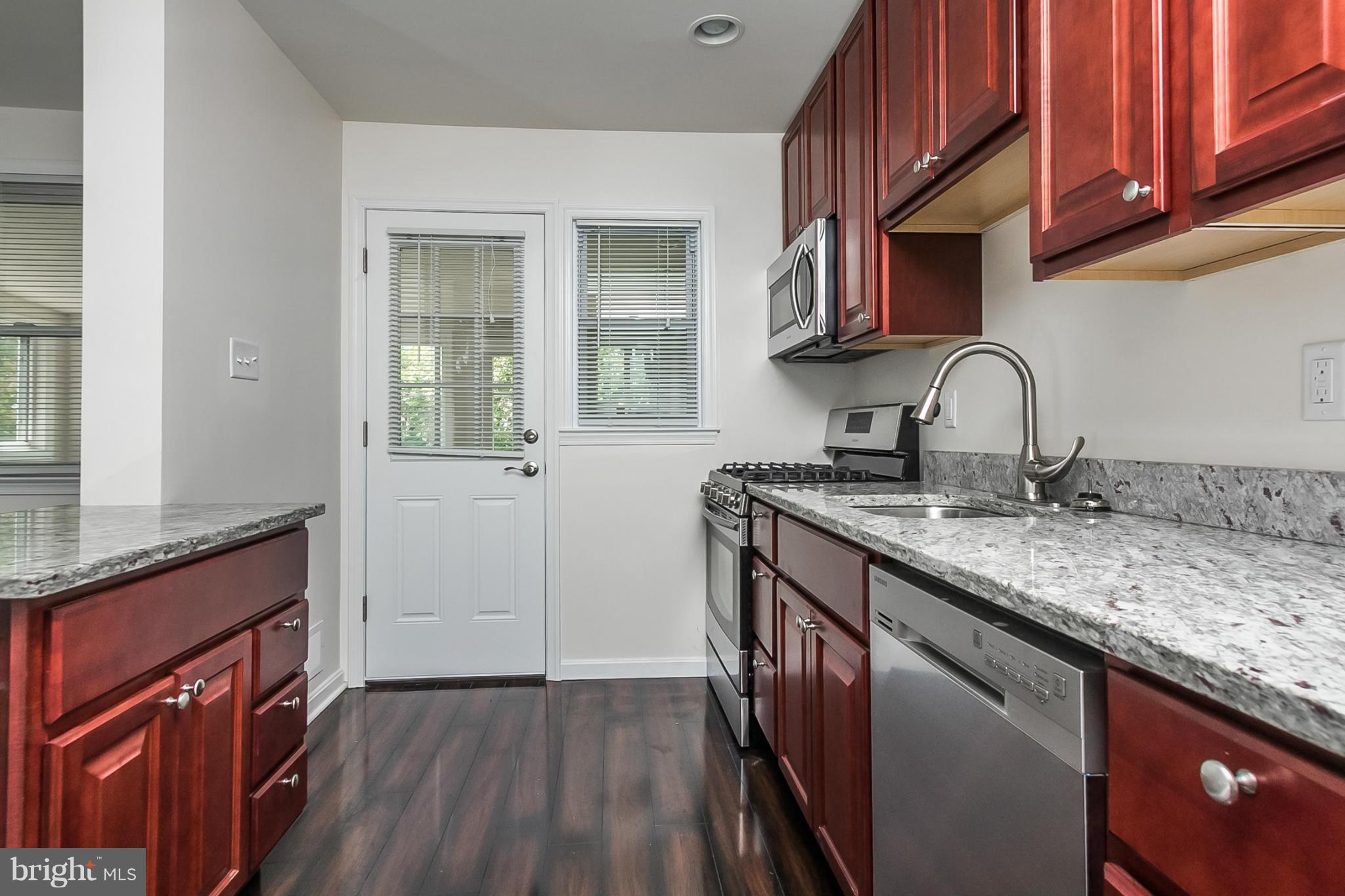 16 Bladen Road Baltimore, MD 21221 - Photo 10 of 29 a kitchen with granite countertop a sink stove and cabinets