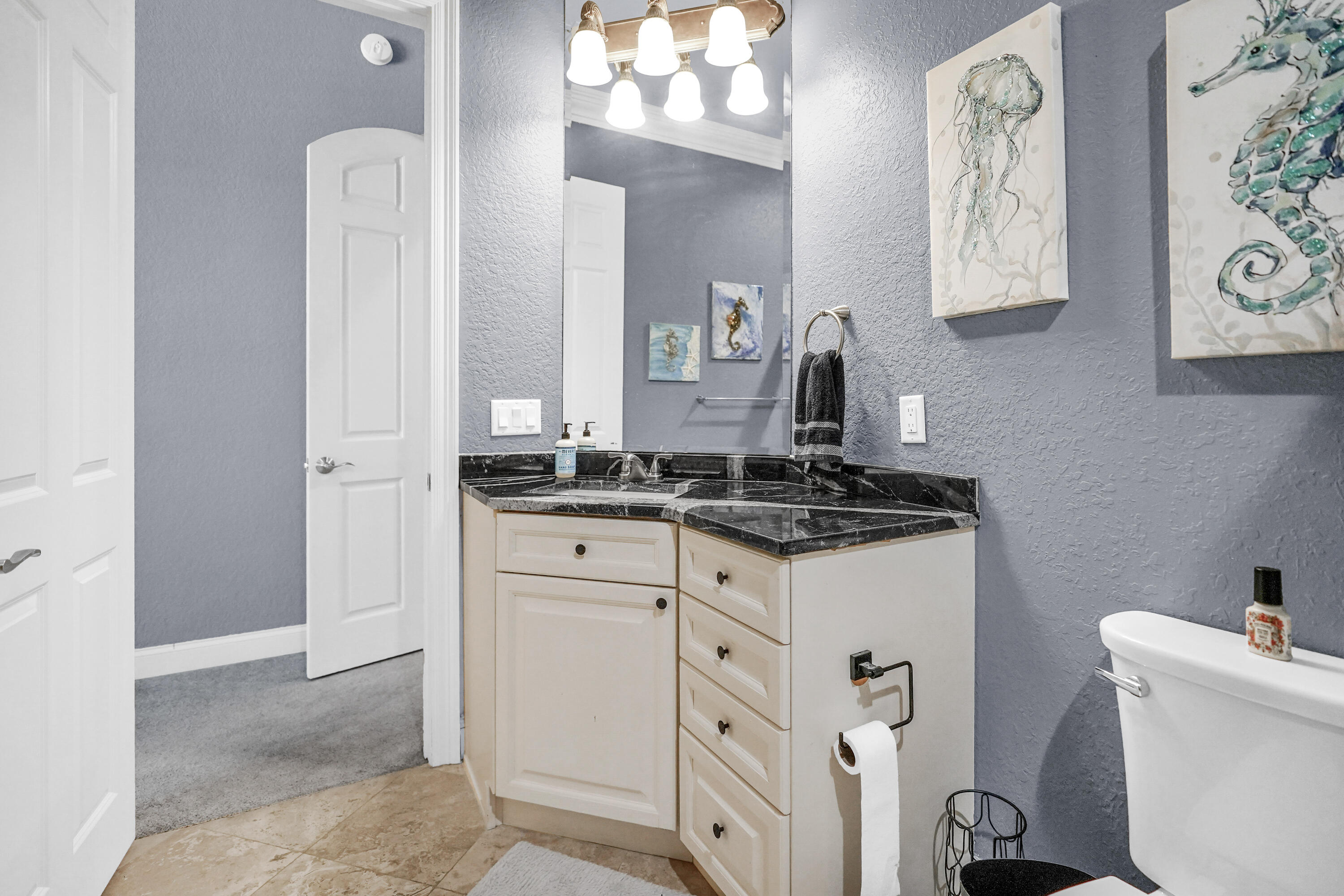 602 Harbor Boulevard, Unit 301 Destin, FL 32541 - Photo 11 of 75 a bathroom with a sink and a mirror