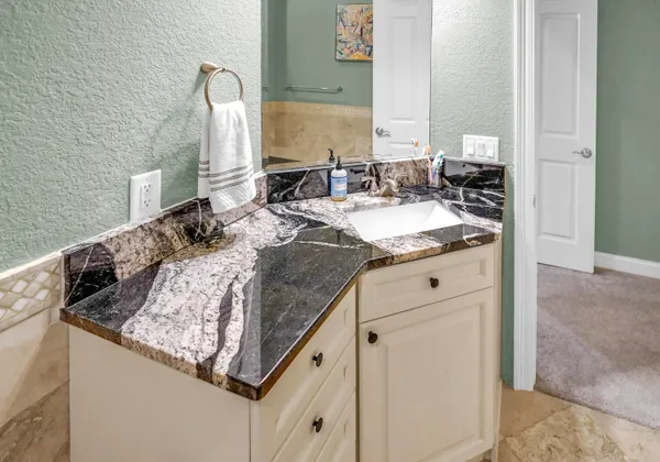 a kitchen with a dining table chairs and refrigerator