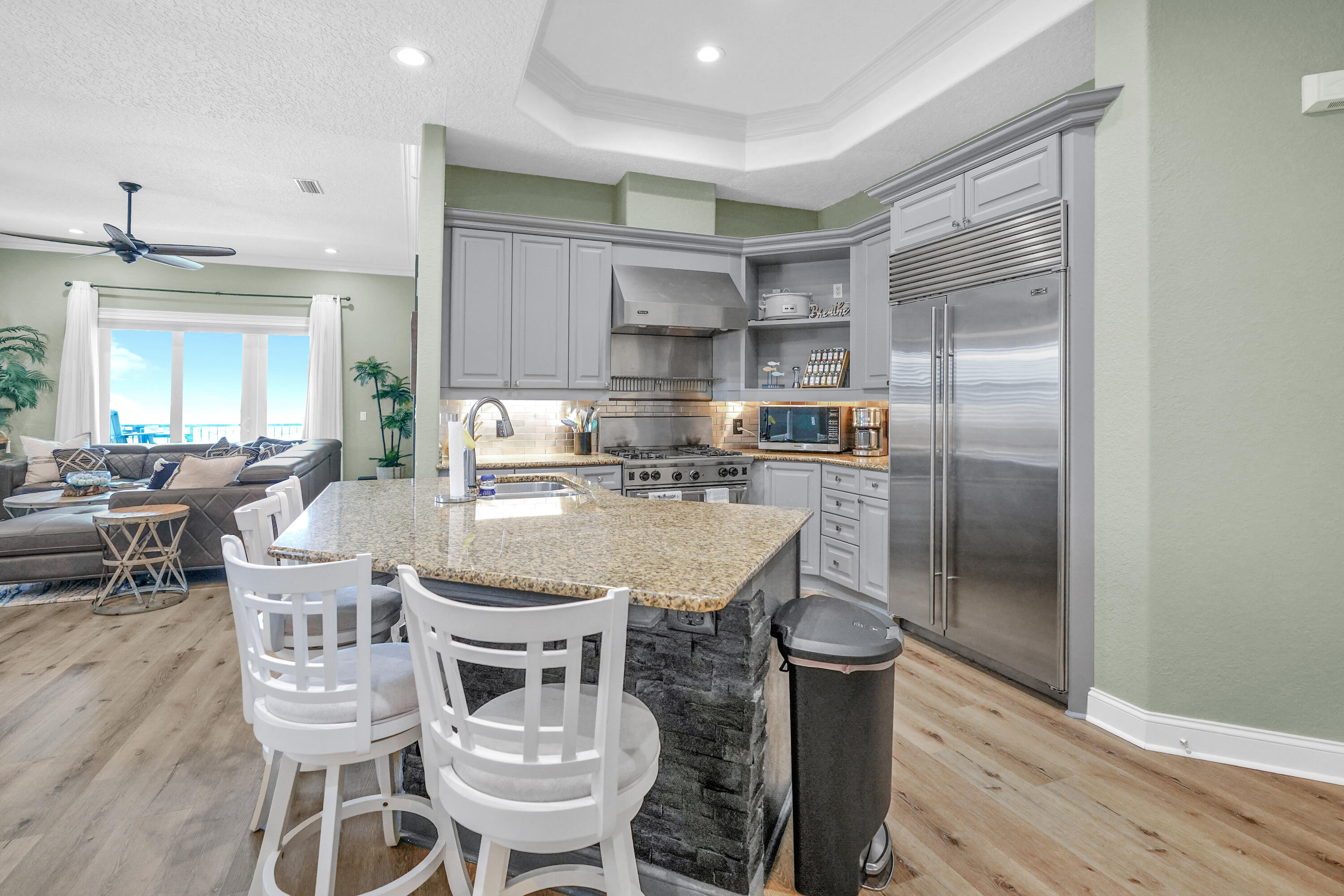602 Harbor Boulevard, Unit 301 Destin, FL 32541 - Photo 19 of 75 a kitchen with a dining table chairs and refrigerator