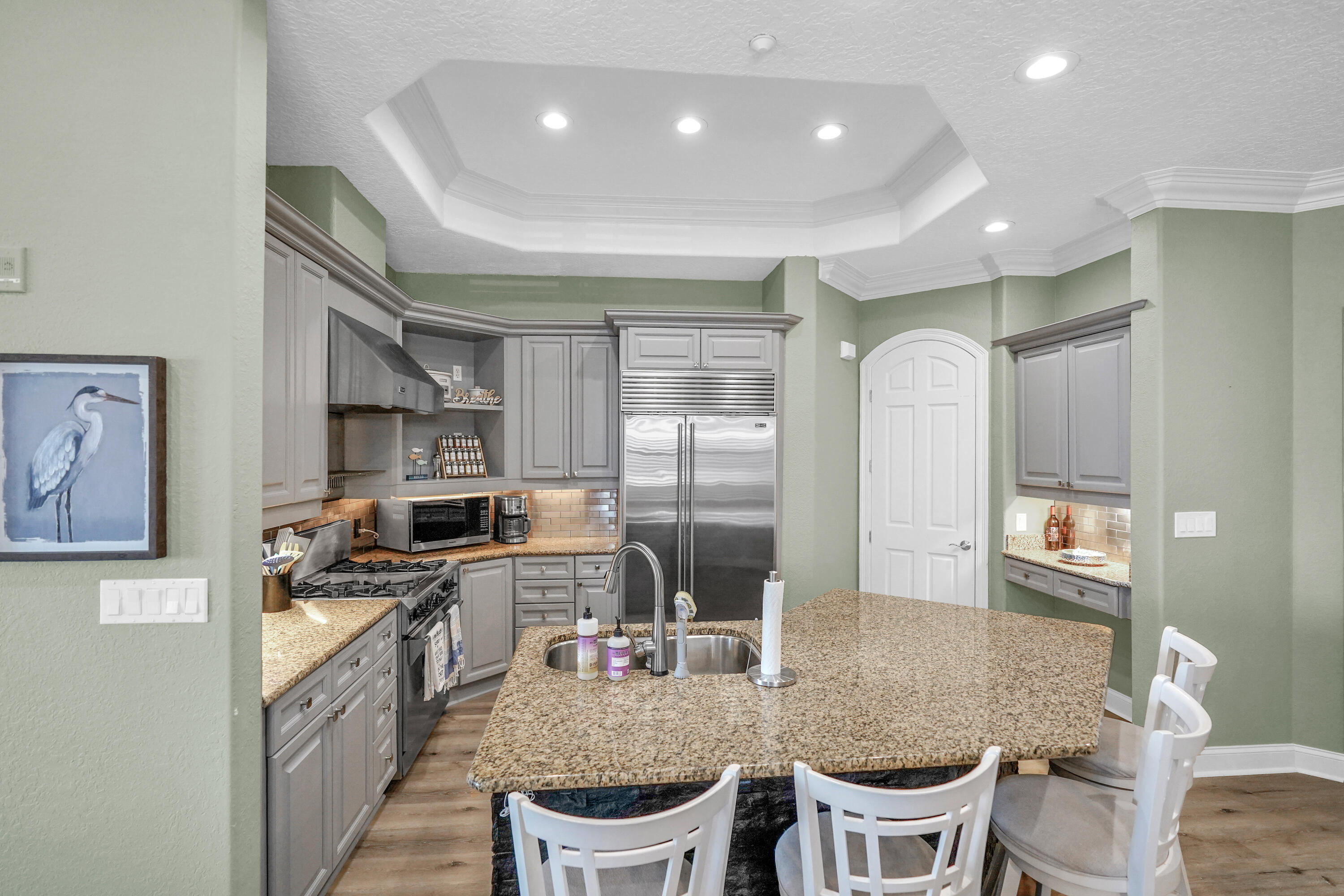 602 Harbor Boulevard, Unit 301 Destin, FL 32541 - Photo 21 of 75 a kitchen with stainless steel appliances granite countertop a stove a sink a refrigerator dining table and chairs
