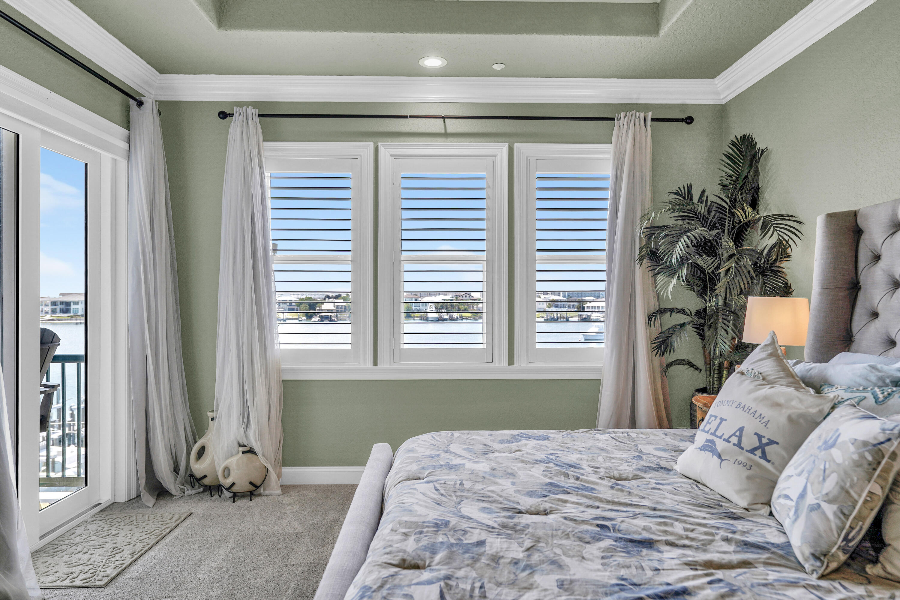 602 Harbor Boulevard, Unit 301 Destin, FL 32541 - Photo 42 of 75 a bedroom with a bed and a window