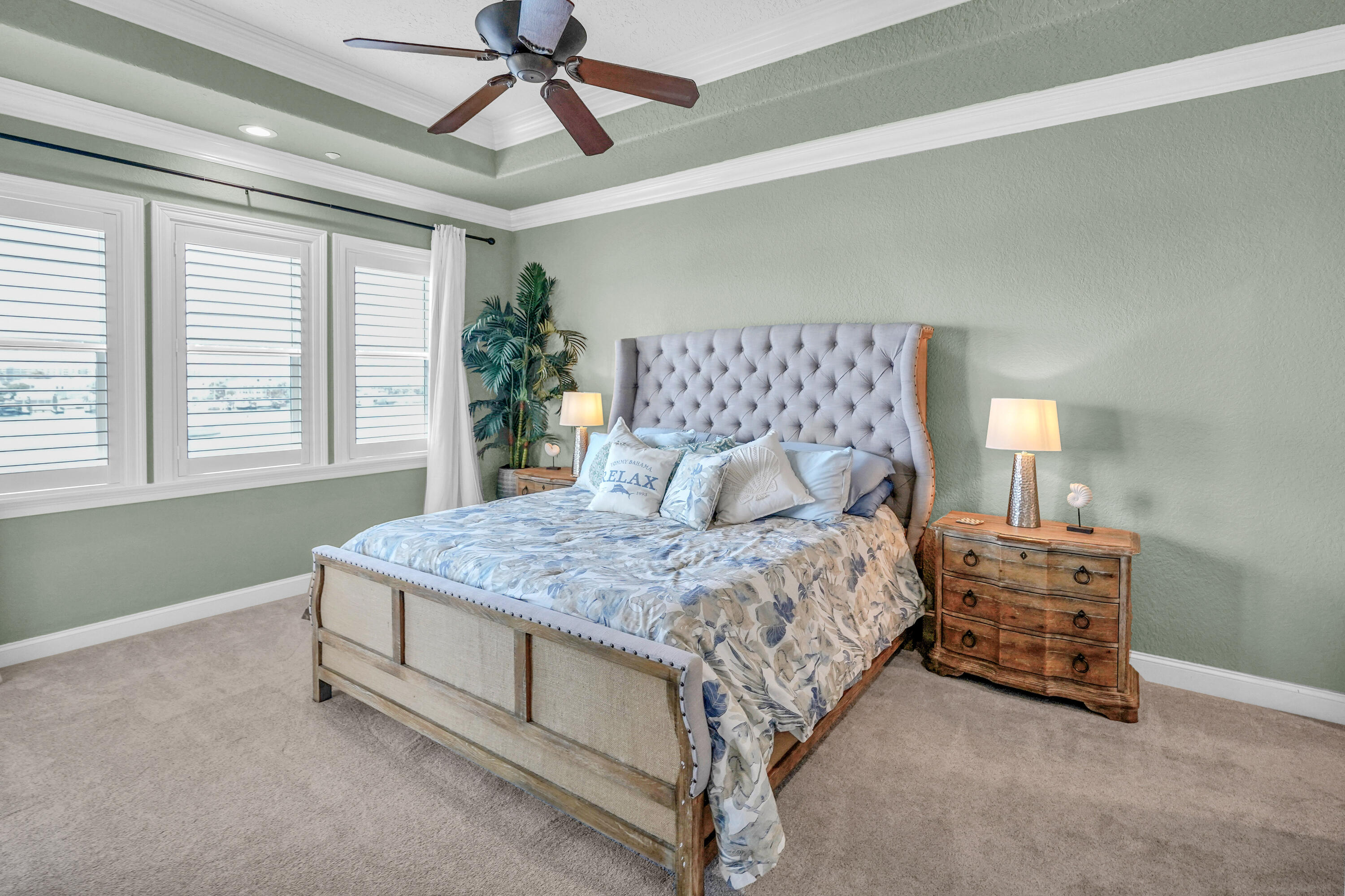 602 Harbor Boulevard, Unit 301 Destin, FL 32541 - Photo 44 of 75 a bedroom with a bed and a chandelier