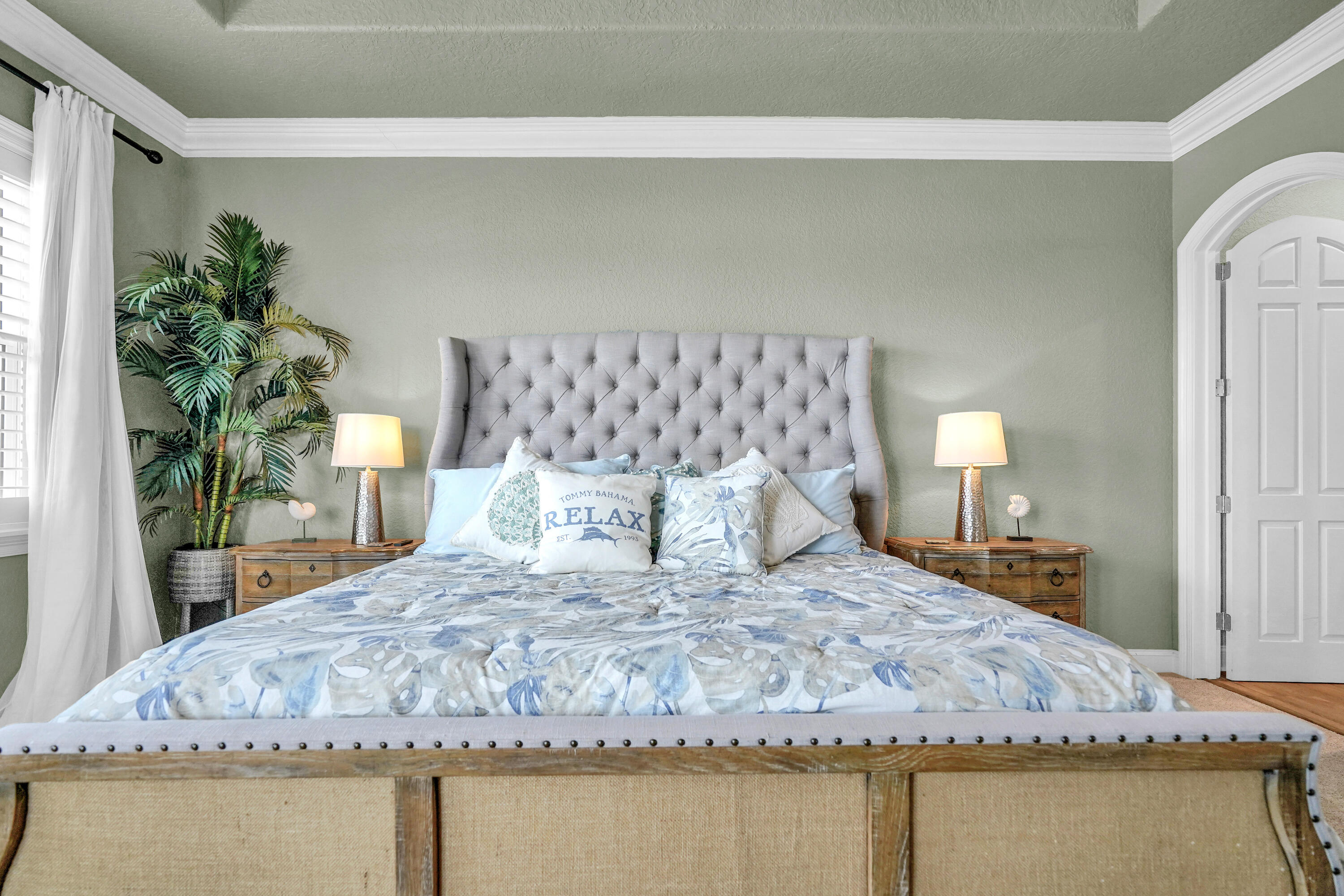 602 Harbor Boulevard, Unit 301 Destin, FL 32541 - Photo 47 of 75 a bedroom with a large bed and a potted plant