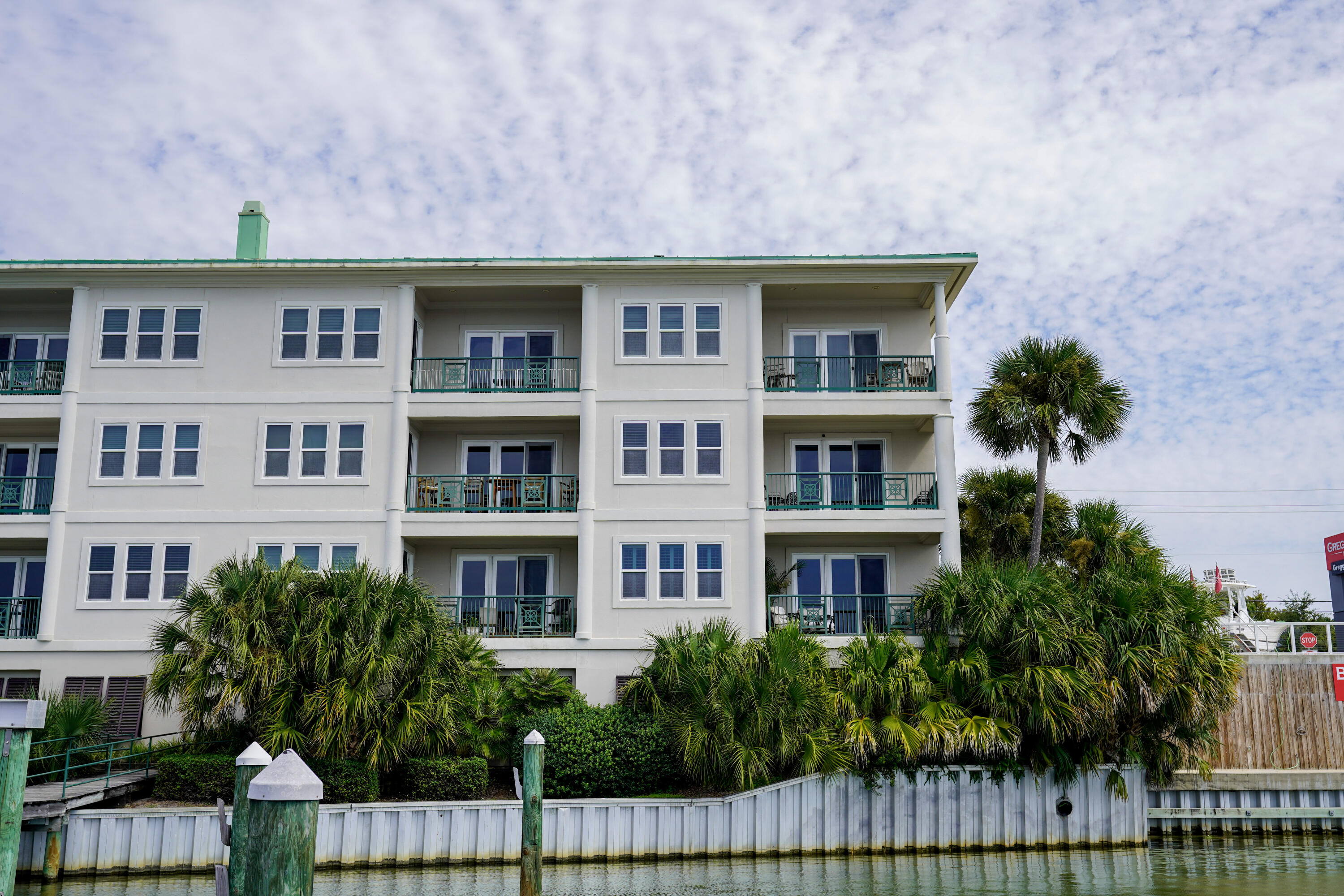 602 Harbor Boulevard, Unit 301 Destin, FL 32541 - Photo 55 of 75 a front view of residential houses with stairs and garden