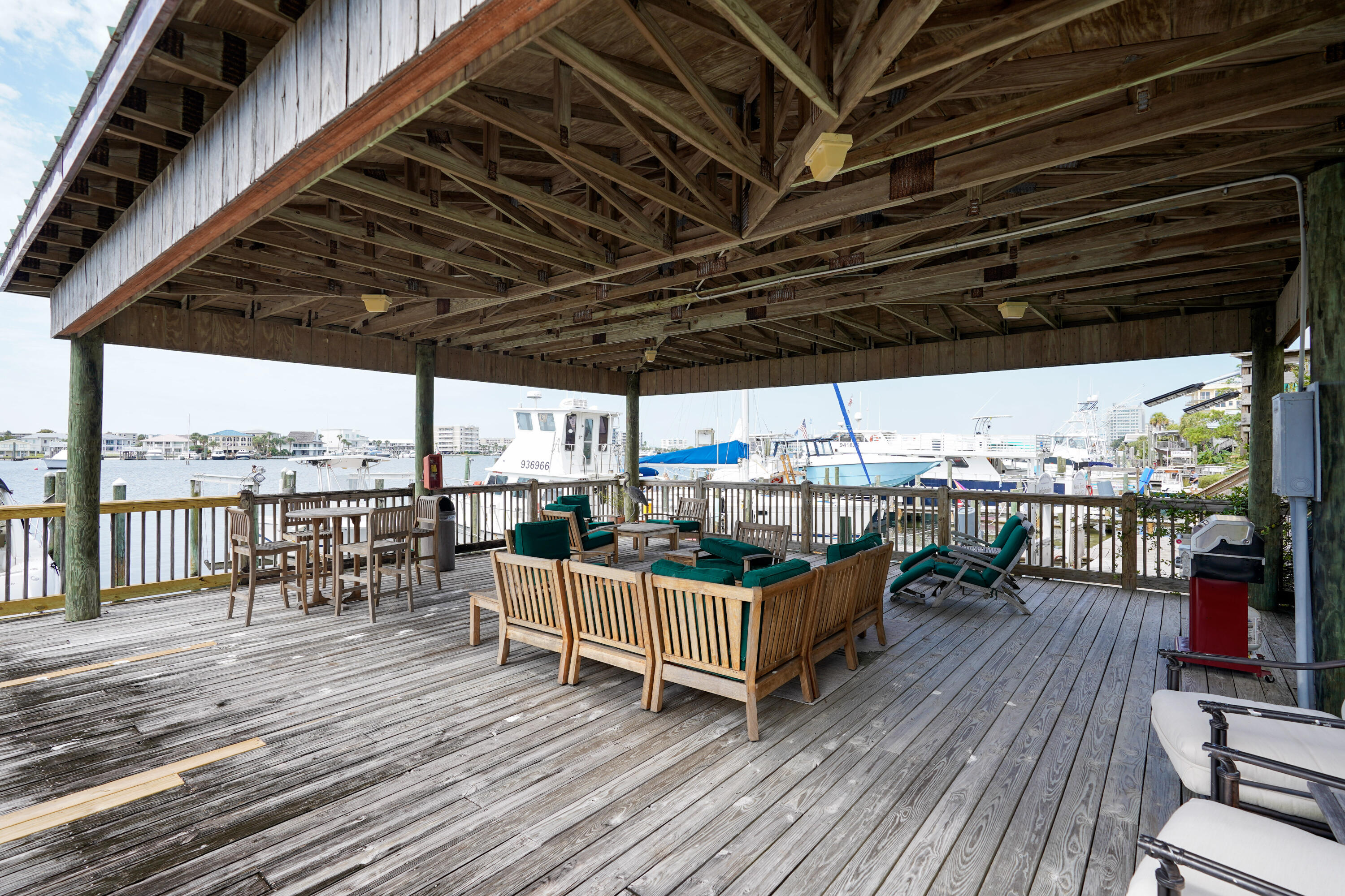 602 Harbor Boulevard, Unit 301 Destin, FL 32541 - Photo 58 of 75 a view of a roof deck with wooden floor barbeque oven and outdoor seating