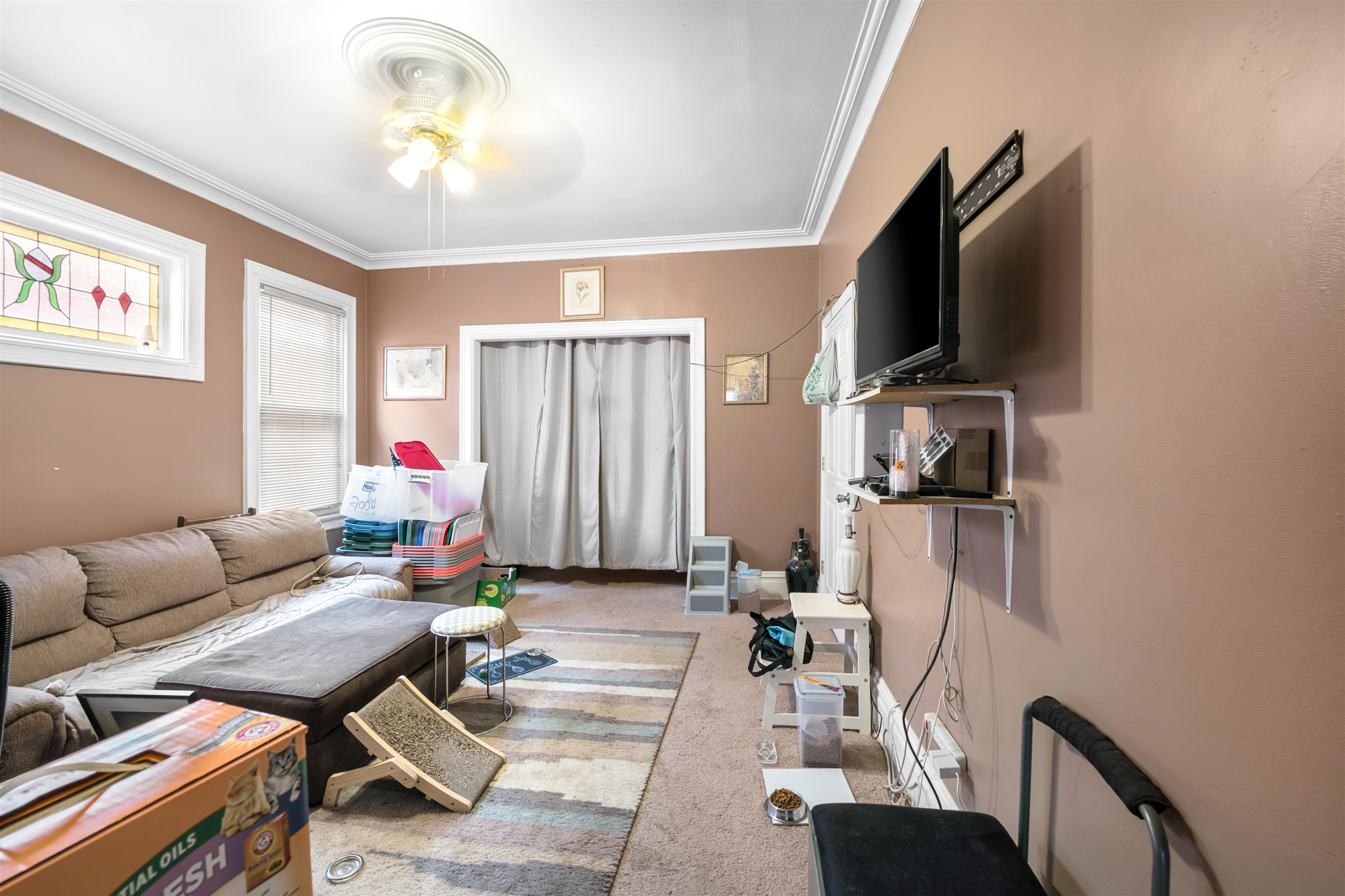154 West 33rd Street Bayonne, NJ 07002 - Photo 16 of 40 a living room with furniture a flat screen tv and a window