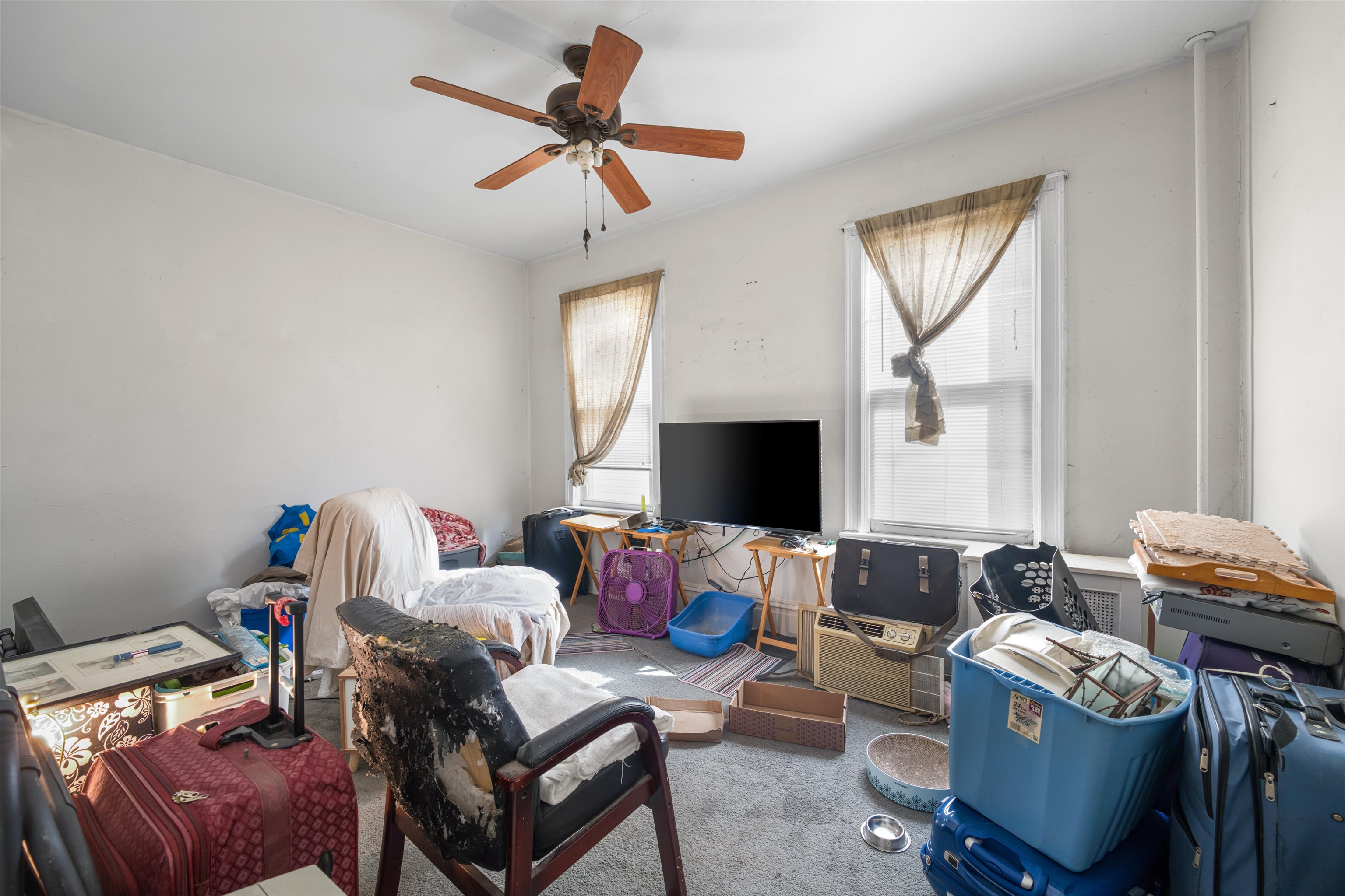 154 West 33rd Street Bayonne, NJ 07002 - Photo 19 of 40 a living room with furniture and a flat screen tv