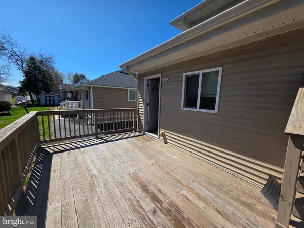 a view of a house with wooden deck