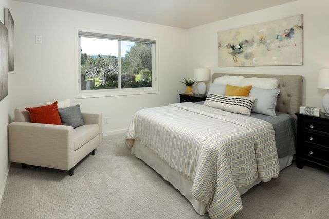 a spacious bedroom with a bed and window